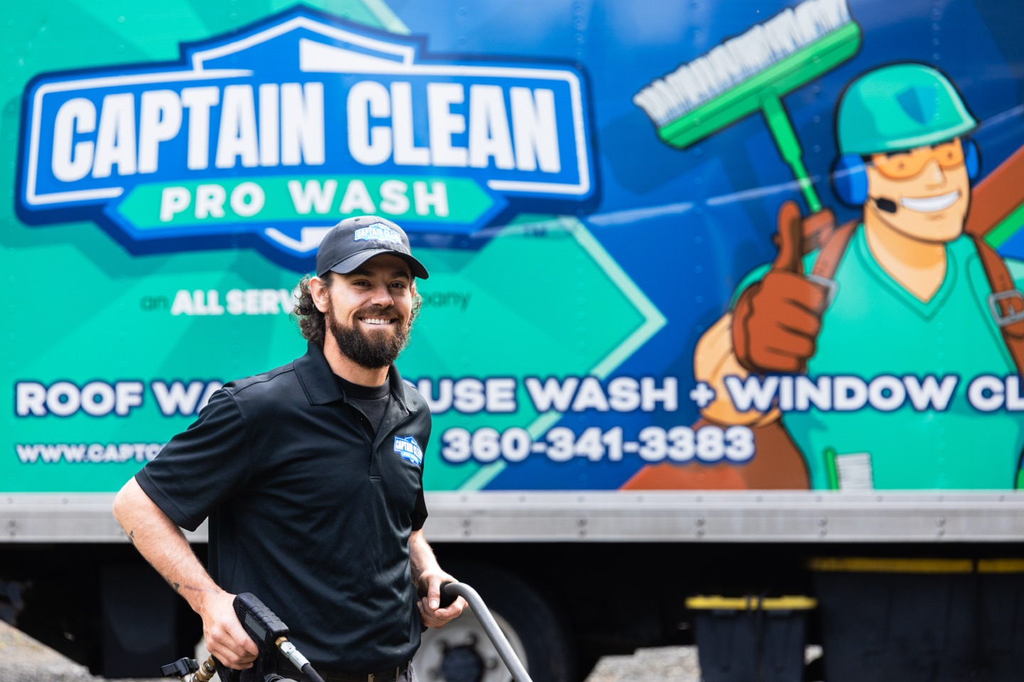 Technician in front of the truck's Captain Clean mascot graphic
