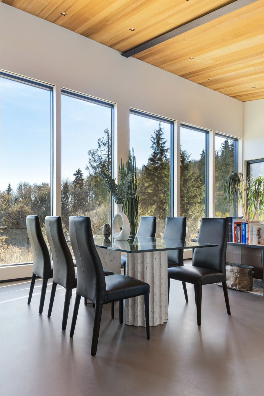 Hillside modern dining room with floor-to-ceiling windows