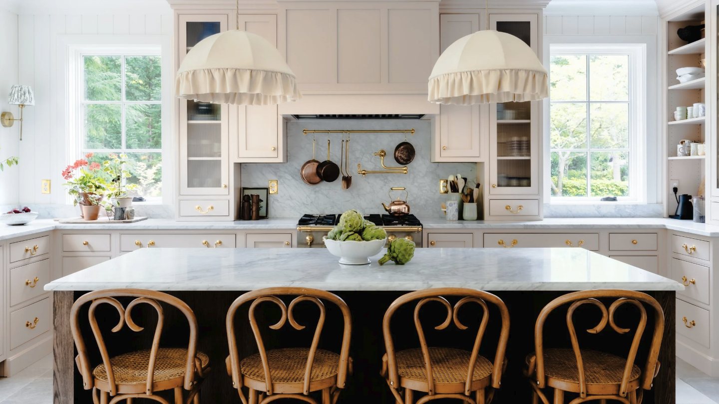 NSS Home kitchen remodel with blush cabinets, a marble island and bentwood stools